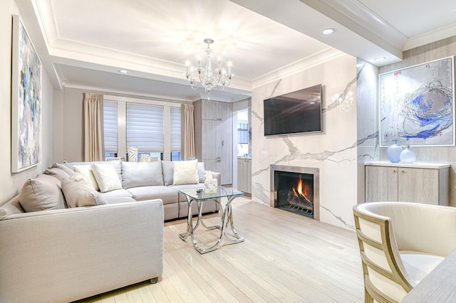 220 E 73rd St Unit 1-A, New York City, NY 10021 - living area with light wood-style floors, ornamental molding, a chandelier, and a fireplace