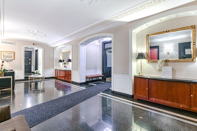 220 E 73rd St Unit 1-A, New York City, NY 10021 - building lobby featuring wainscoting, a decorative wall, and ornamental molding