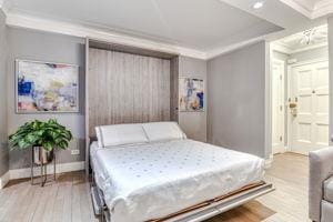 220 E 73rd St Unit 1-A, New York City, NY 10021 - bedroom featuring crown molding, wood finished floors, baseboards, and recessed lighting
