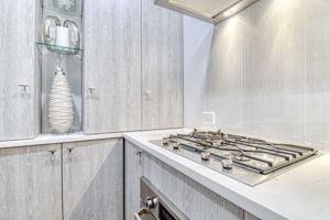 220 E 73rd St Unit 1-A, New York City, NY 10021 - kitchen view of stainless steel gas stovetop and light countertops