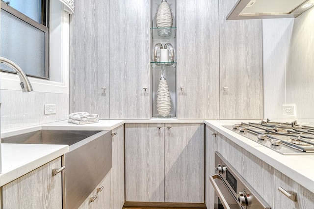 220 E 73rd St Unit 1-A, New York City, NY 10021 - kitchen with stainless steel appliances, light countertops, premium range hood, and light brown cabinets