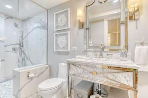 220 E 73rd St Unit 1-A, New York City, NY 10021 - bathroom with a marble finish shower, toilet, and vanity