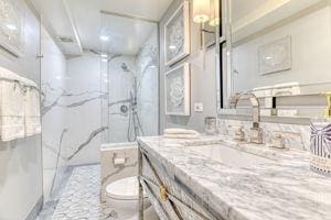 220 E 73rd St Unit 1-A, New York City, NY 10021 - full bathroom featuring toilet, vanity, and a marble finish shower