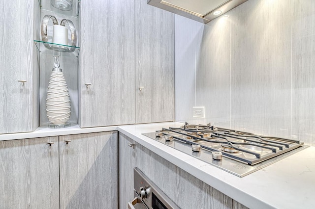 220 E 73rd St Unit 1-A, New York City, NY 10021 - kitchen with stainless steel gas cooktop, light countertops, and ventilation hood