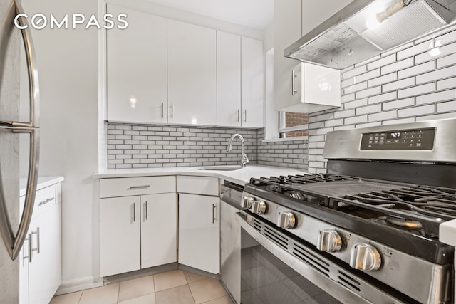640 W 231st St Unit 5Ff, New York City, NY 10463 - kitchen featuring appliances with stainless steel finishes, exhaust hood, light countertops, and white cabinets