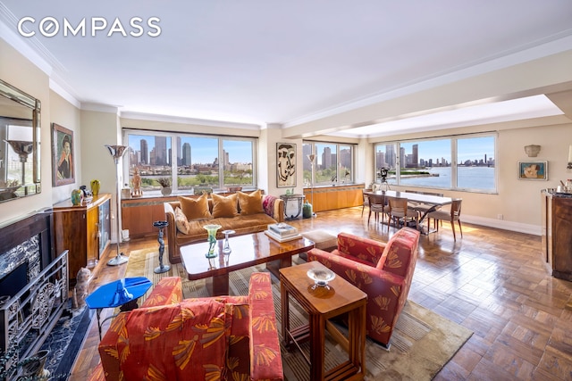 living room featuring a view of skyline, a fireplace, crown molding, and baseboards