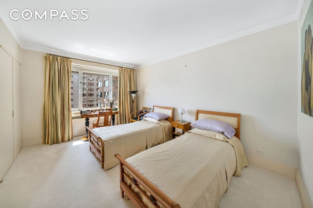 bedroom with light colored carpet, ornamental molding, and a closet
