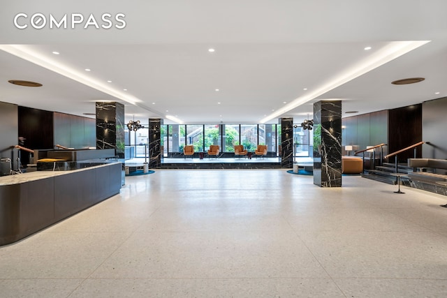 25 Sutton Pl S Unit 8G, New York City, NY 10022 - building lobby featuring expansive windows, recessed lighting, and stairway