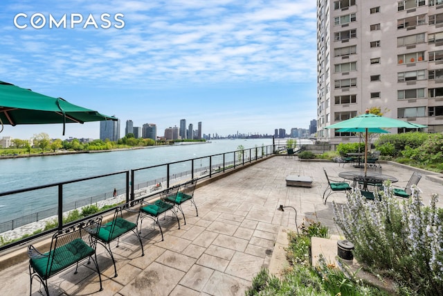 view of patio featuring a view of skyline and a water view