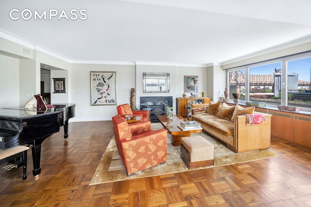 living room with ornamental molding and baseboards