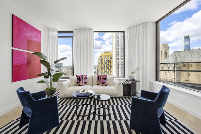 75 Wall St Unit Phl3, New York City, NY 10005 - living room featuring a view of city, baseboards, and wood finished floors