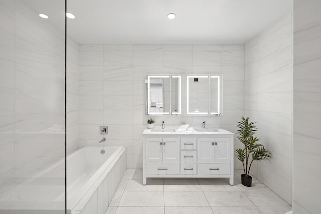 75 Wall St Unit Phl3, New York City, NY 10005 - full bath featuring tile patterned floors, tile walls, double vanity, tiled tub, and recessed lighting