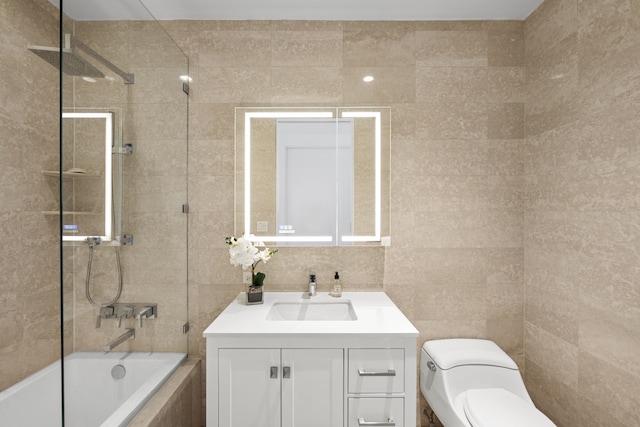 75 Wall St Unit Phl3, New York City, NY 10005 - bathroom featuring tile walls, tiled shower / bath, vanity, and toilet