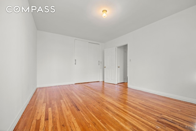 unfurnished room featuring light wood finished floors and baseboards