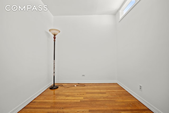 empty room with wood finished floors and baseboards