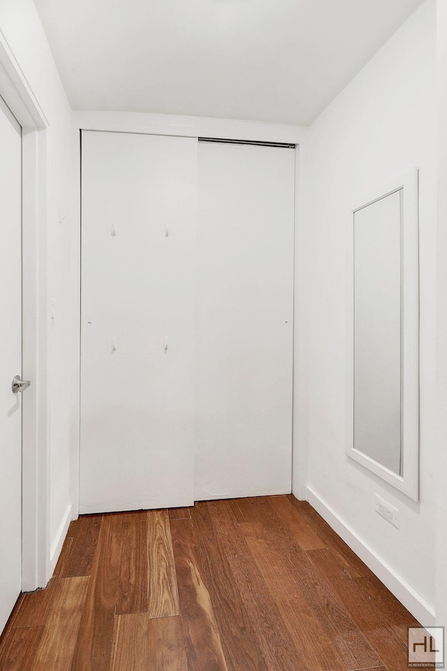 unfurnished bedroom featuring a closet and wood finished floors