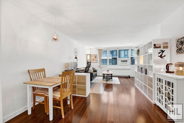 240 E 35th St Unit 5C, New York City, NY 10016 - dining space with radiator heating unit, dark wood-type flooring, and baseboards
