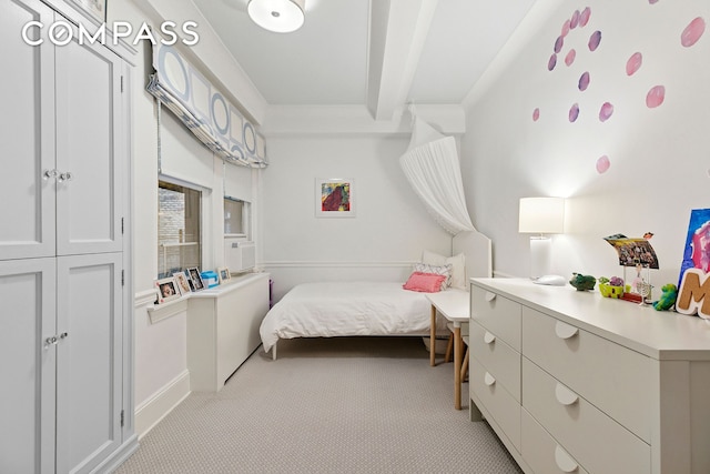 bedroom featuring light colored carpet and baseboards
