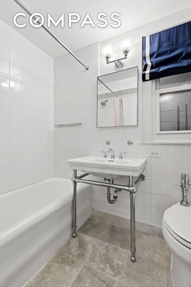205 E 69th St Unit 3A, New York City, NY 10021 - full bathroom featuring tile walls, tub / shower combination, toilet, and tile patterned flooring