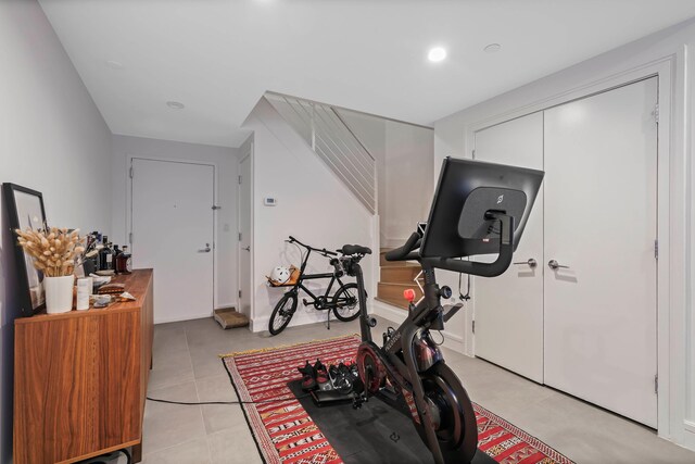 exercise room with light tile patterned floors