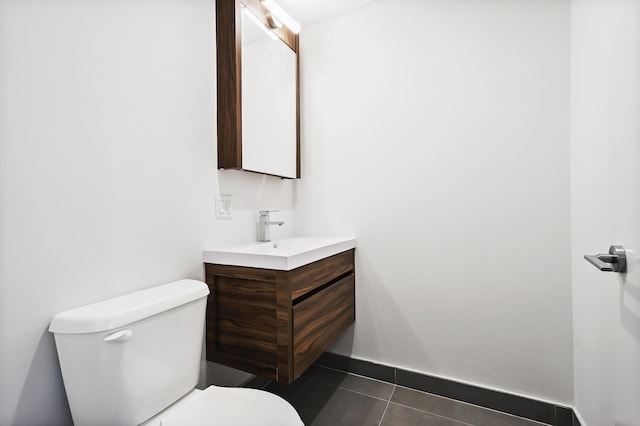 bathroom with tile patterned flooring, vanity, and toilet