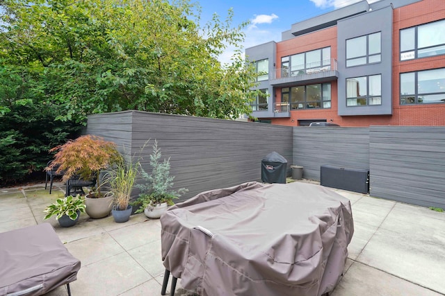 view of patio featuring fence