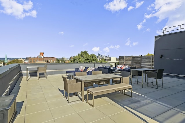 view of patio featuring outdoor dining space and a view of city