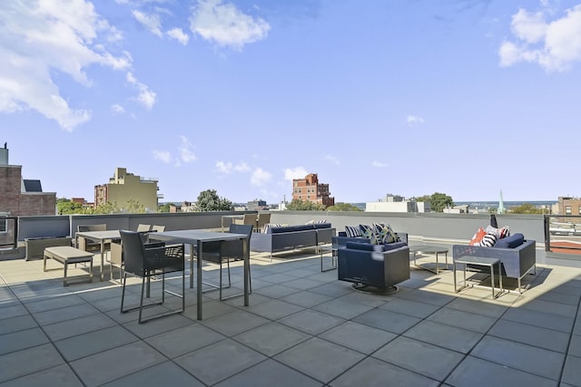 view of patio / terrace featuring an outdoor hangout area and a city view
