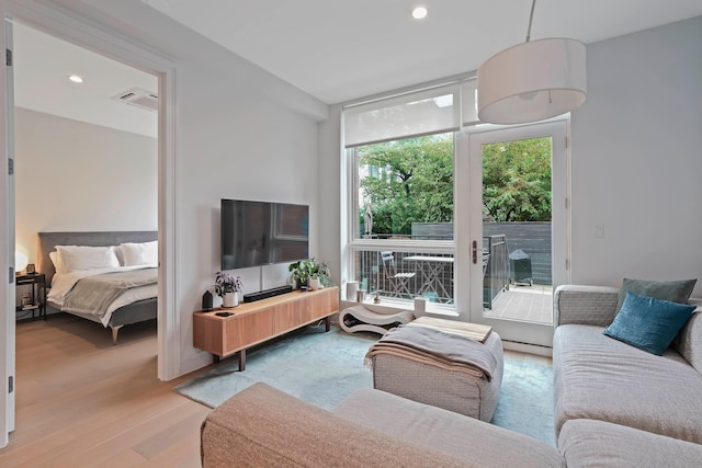 living area with wood finished floors and recessed lighting