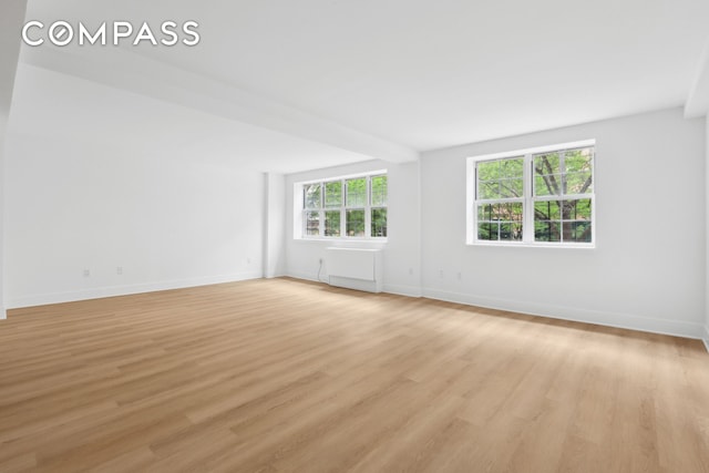 empty room featuring light wood-style floors and baseboards