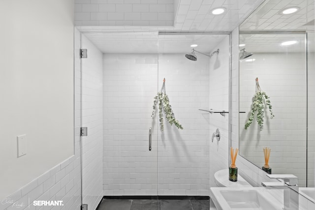 270 W 17th St Unit 12Bc, New York City, NY 10011 - bathroom featuring recessed lighting, a stall shower, tile walls, and vanity