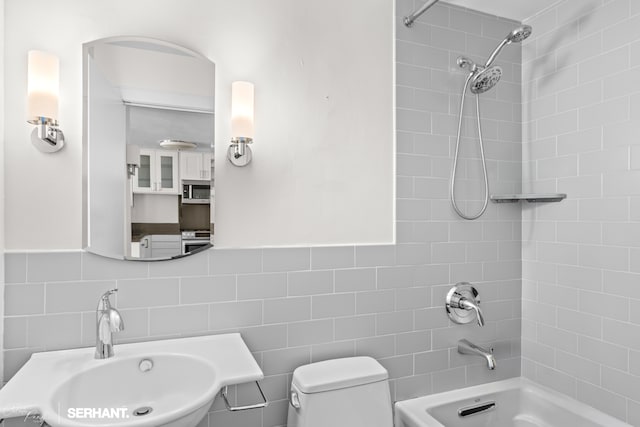 270 W 17th St Unit 12Bc, New York City, NY 10011 - bathroom with bathtub / shower combination, a sink, and toilet