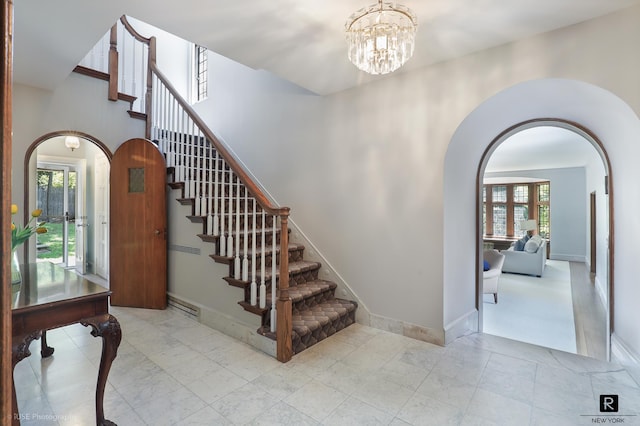 4500 Fieldston Rd, New York City, NY 10471 - foyer entrance with arched walkways, stairway, and a chandelier