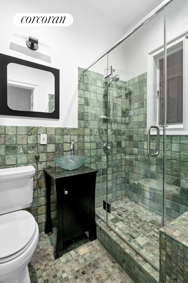 352 W 12th Street Maisonette, New York City, NY 10014 - bathroom featuring vanity, tile walls, toilet, and a stall shower