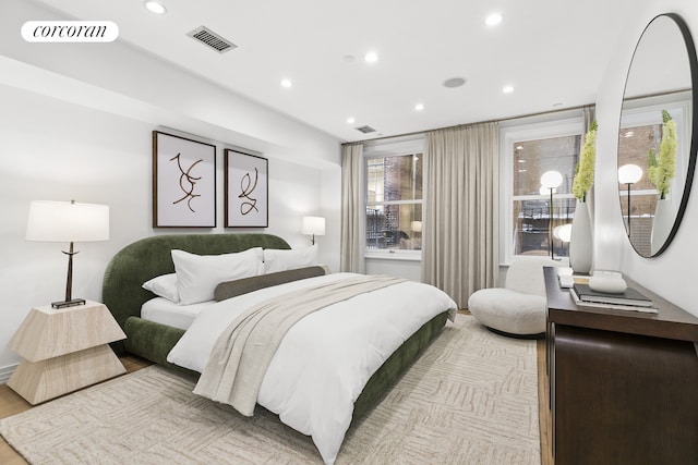 bedroom with recessed lighting, multiple windows, and light wood-style floors