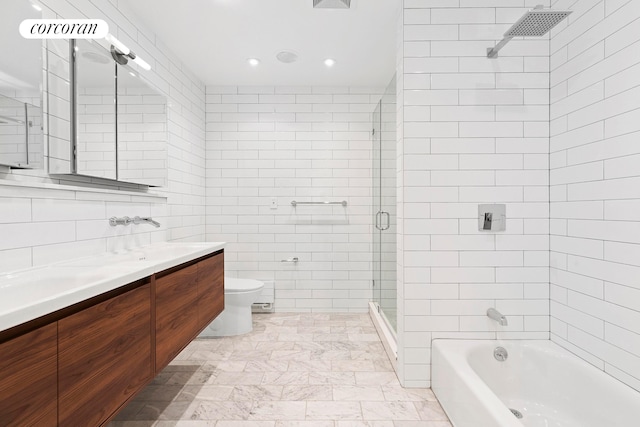 bathroom with tile walls, a shower with shower door, toilet, a bath, and double vanity