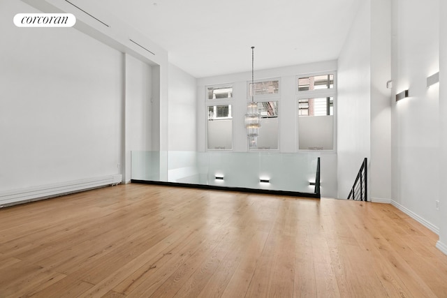 empty room featuring hardwood / wood-style floors and baseboards