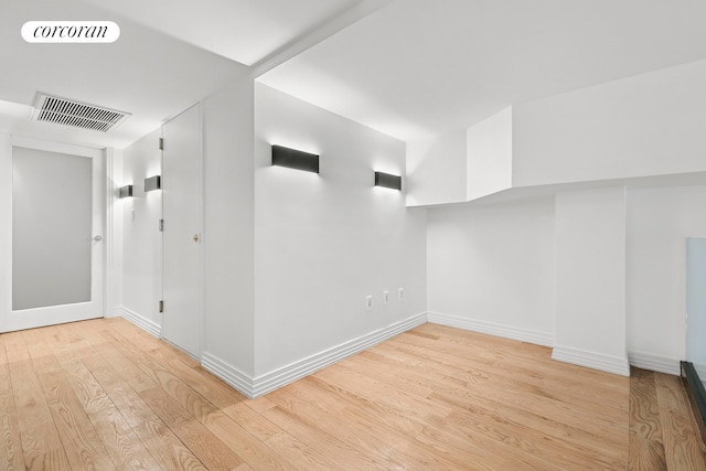 unfurnished room featuring wood finished floors and baseboards
