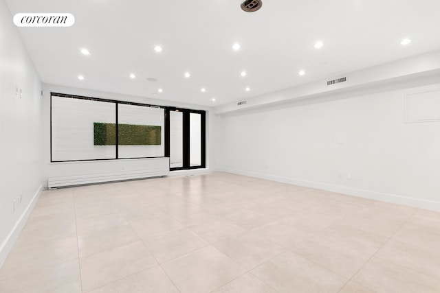 unfurnished room featuring recessed lighting, baseboards, and baseboard heating