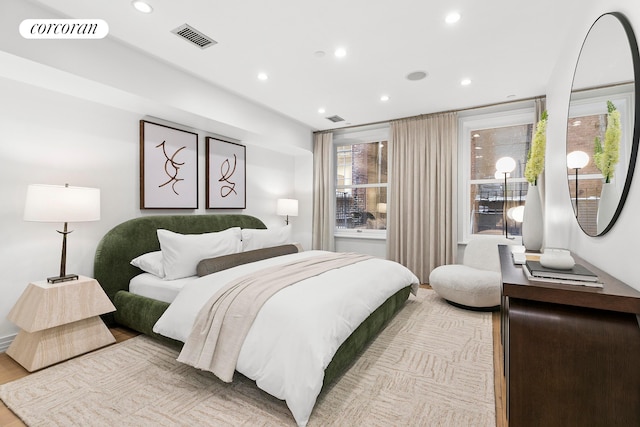 bedroom with recessed lighting, multiple windows, and light wood-style flooring