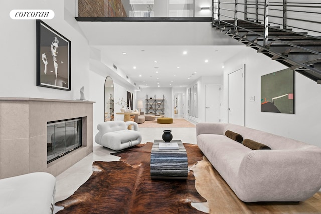 living area with recessed lighting and a tile fireplace