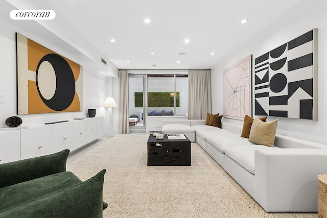carpeted living area with recessed lighting