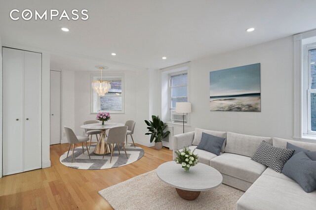 61 E 77th St Unit 5F, New York City, NY 10075 - living area with wood finished floors, recessed lighting, and a chandelier