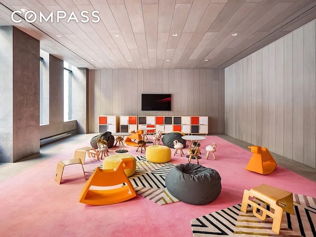 recreation room featuring recessed lighting, carpet flooring, and wood walls