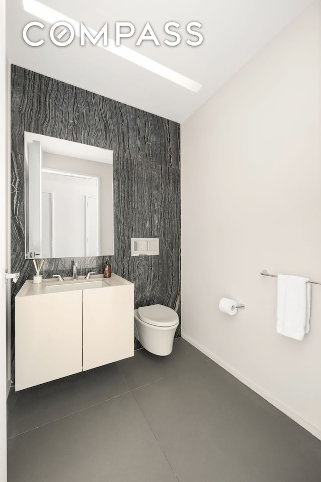 bathroom featuring toilet and vanity