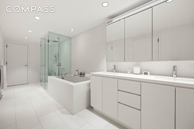 425 W 53rd St Unit 604, New York City, NY 10019 - full bathroom featuring a shower stall, a bath, double vanity, recessed lighting, and tasteful backsplash