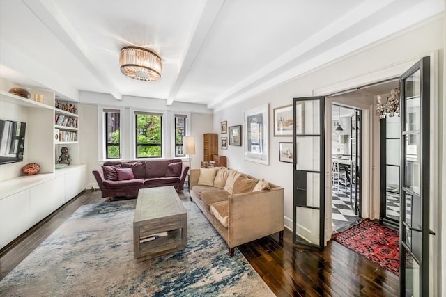 living room featuring hardwood / wood-style floors, beamed ceiling, and a chandelier
