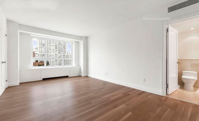 200 E 66th St Unit C1605, New York City, NY 10065 - empty room with wood finished floors and baseboards