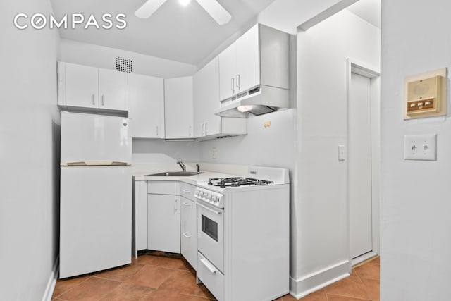 132 W 71st St Unit 3, New York City, NY 10023 - kitchen featuring white appliances, under cabinet range hood, a sink, light countertops, and white cabinetry