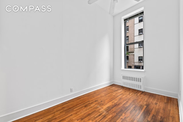 132 W 71st St Unit 3, New York City, NY 10023 - empty room with radiator, dark wood-style floors, baseboards, and ceiling fan